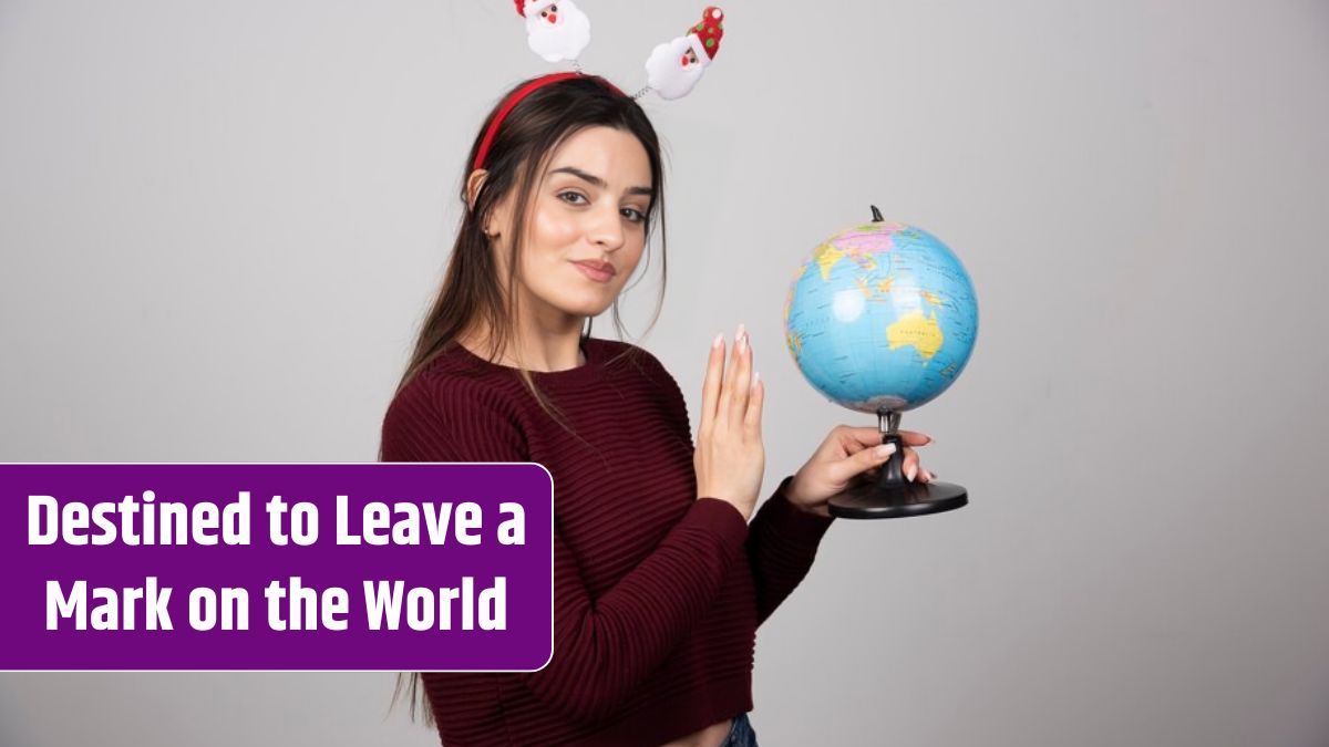 Young woman in Christmas headband holding an Earth globe.